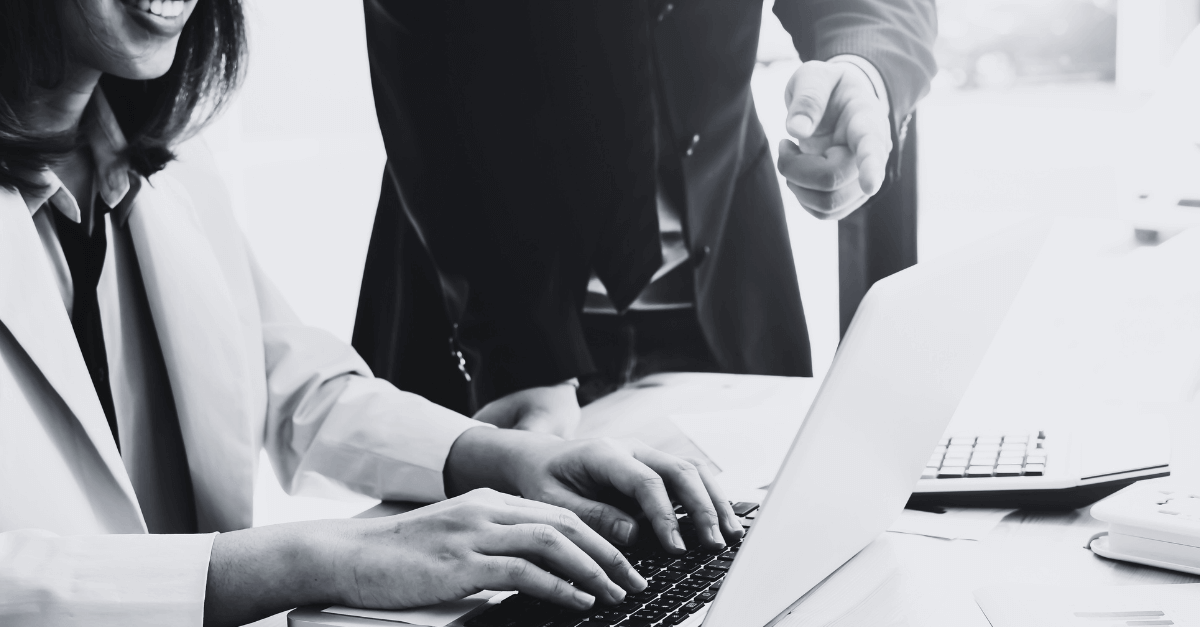 Pessoas em escritório mexendo em um notebook